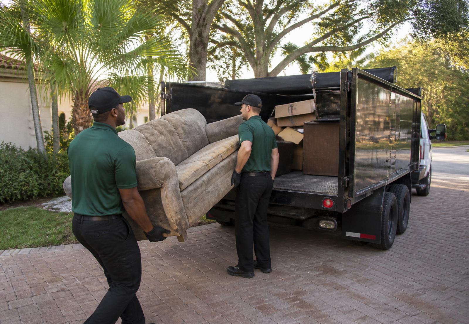 Oliv Grove crew loading furniture into a hauling truck at an Ocala, FL home